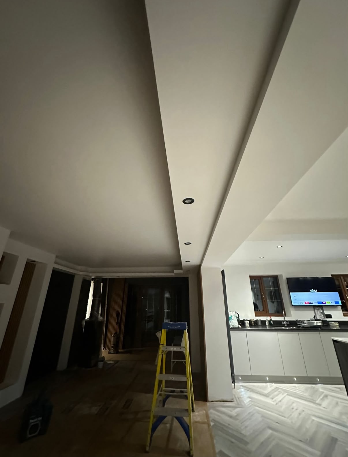 Completed modern open-plan kitchen renovation with herringbone flooring in a South Wales home